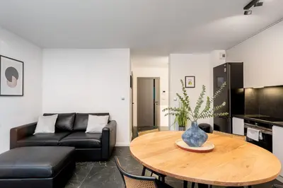 a living room with a table and a couch at Apartments Deluxe Cannes 51 by BookingHost in Kraków