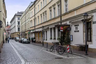 a street with buildings and a bike parked on the street at Św Tomasza Old Town, Sun & Snow in Kraków