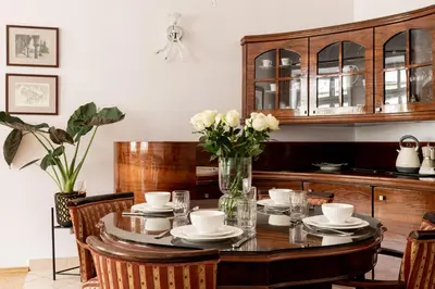 a dining room table with a vase of flowers at Św Tomasza Old Town, Sun & Snow in Kraków