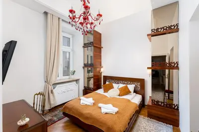 a bedroom with a bed with towels on it at Św Tomasza Old Town, Sun & Snow in Kraków