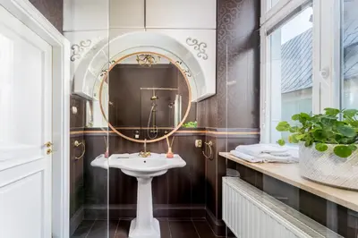 a bathroom with a sink and a mirror at Św Tomasza Old Town, Sun & Snow in Kraków