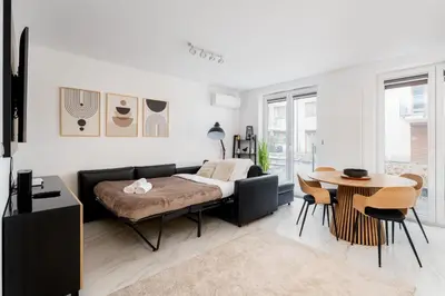 a living room with a couch and a table at Apartments Deluxe Amsterdam 02 by BookingHost in Kraków