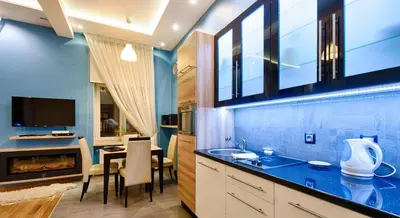 a kitchen with a sink and a dining room at Krakow Views - Stylish Apartments in Kazimierz in Kraków