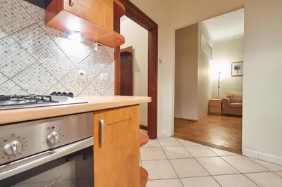 a kitchen with a sink and a stove at Krakow Views - Stylish Apartments in Kazimierz in Kraków