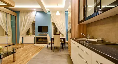 a kitchen with a table and a dining room at Krakow Views - Stylish Apartments in Kazimierz in Kraków
