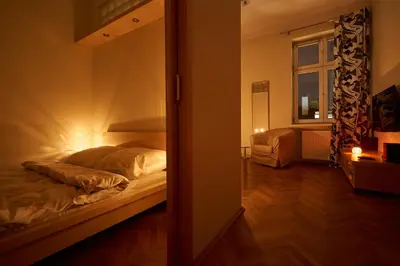 a bedroom with a bed in a room with a mirror at Krakow Views - Stylish Apartments in Kazimierz in Kraków