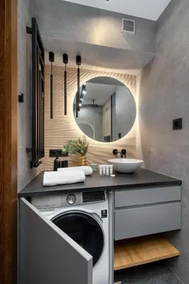a bathroom with a washing machine and a mirror at Lubicz Stylish Apartment with Parking and Air Conditioning in the City Center by Noclegi Renters in Kraków