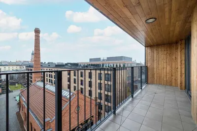 a balcony with a view of a building at Lubicz Stylish Apartment with Parking and Air Conditioning in the City Center by Noclegi Renters in Kraków
