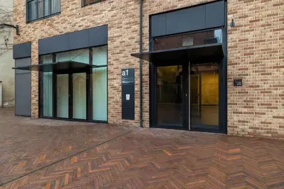 a brick building with a pay phone in front of it at Lubicz Stylish Apartment with Parking and Air Conditioning in the City Center by Noclegi Renters in Kraków