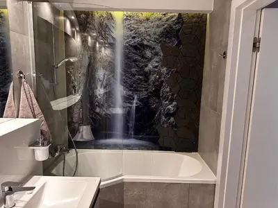 a bathroom with a bath tub and a sink at Apartamenty Figaretti Rakowicka in Kraków