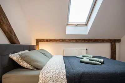 a bed with two pillows on it in a room at Apartamenty Borek przy Modrej in Kraków