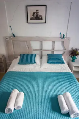 a bed with two blue and white towels on it at Pilotow 87 Apartments in Kraków