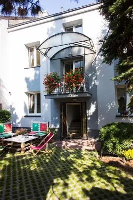 a building with a balcony with flowers on it at Pilotow 87 Apartments in Kraków
