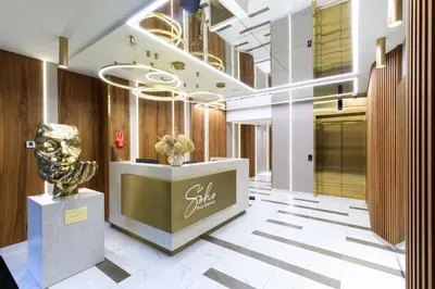 a lobby with a statue in the middle of a building at Soho Residence in Kraków