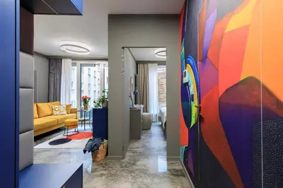 a living room with a colorful painting on the wall at Soho Residence in Kraków
