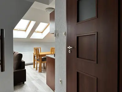 a dining room with a table and two chairs at Apartament Serwis in Kraków