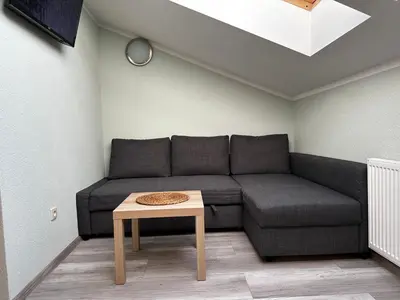 a small kitchen with wooden cabinets and a microwave at Apartament Serwis in Kraków