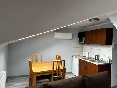 a hotel room with two beds and a tv at Apartament Serwis in Kraków