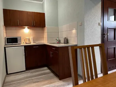 a bedroom with purple walls and a bed with a mirror at Apartament Serwis in Kraków