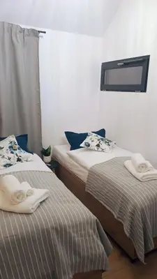 two beds sitting next to each other in a room at Wiatrem Pisane in Roczyny