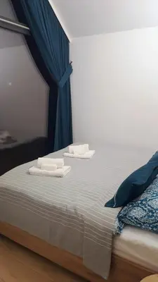 a bedroom with a bed with two towels on it at Wiatrem Pisane in Roczyny