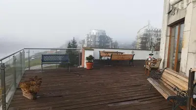 a deck with benches and tables on a building at Wisła Sunset in Kraków