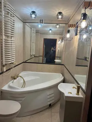 a bathroom with a tub and a toilet and a sink at Wisła Sunset in Kraków