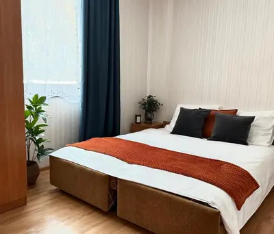 a bedroom with a large bed in front of a window at Ponikiew Resort in Wadowice