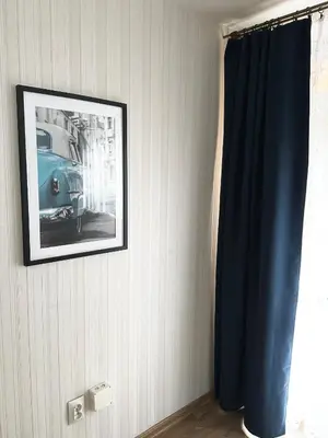a picture hanging on a wall with a blue curtain at Ponikiew Resort in Wadowice