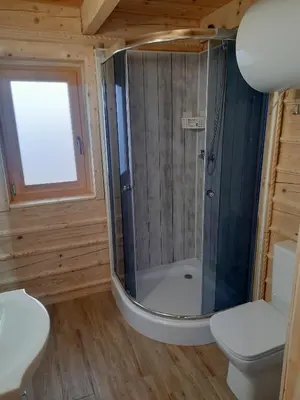 a bathroom with a shower and a toilet at Domek na Przełęczy 2 in Wierzbanowa