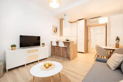 a living room with a couch and a tv and a table at Kołłątaja Spacious Modern Apartment - by Upstairs in Kraków