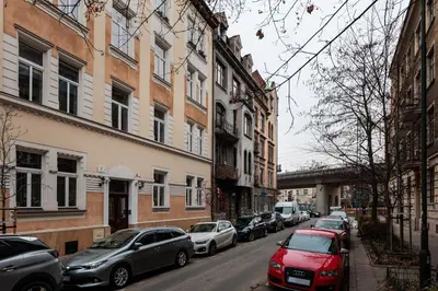 a row of cars parked on a city street at Kołłątaja Spacious Modern Apartment - by Upstairs in Kraków