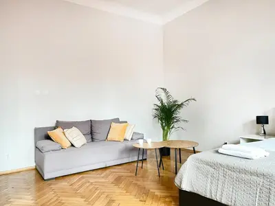 a living room with a couch and a table at Cozy Apartment for family next to Wawel & Old Town in Kraków
