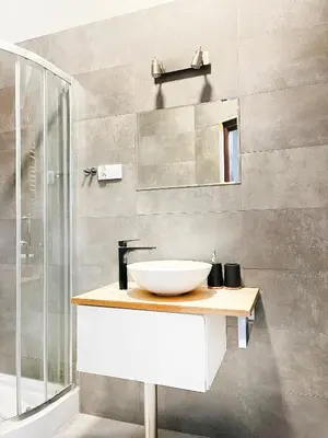 a bathroom with a white sink and a shower at Cozy Apartment for family next to Wawel & Old Town in Kraków