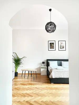 a bedroom with a bed and a table at Cozy Apartment for family next to Wawel & Old Town in Kraków