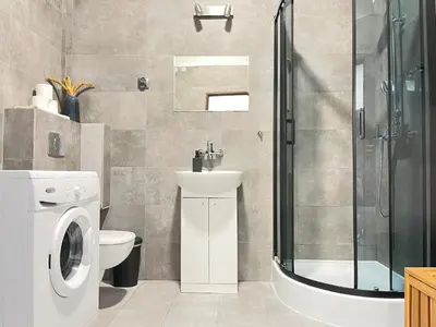 a bathroom with a toilet sink and a shower at Cozy Apartment for family next to Wawel & Old Town in Kraków
