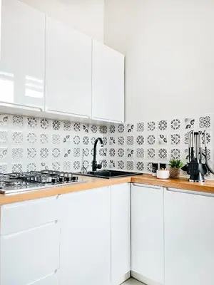 a white kitchen with white cabinets and a sink at Cozy Apartment for family next to Wawel & Old Town in Kraków