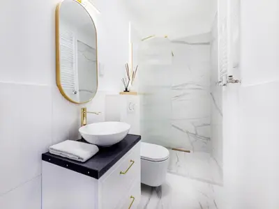 a white bathroom with a sink and a mirror at Apartament Długa 82 in Kraków