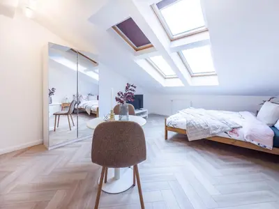 a bedroom with a bed and a desk with a chair at Apartament Długa 82 in Kraków