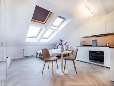 a kitchen and dining room with a table and chairs at Apartament Długa 82 in Kraków