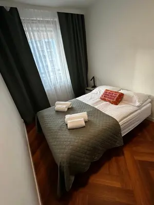 a bedroom with a bed with two towels on it at Apartament Bajeczny 87 - 5 min to Tauron Arena Cracow - beside the Vistula River in Kraków