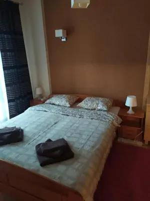 a bedroom with a bed with two bags on it at Origami Apartament in Kraków