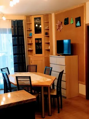 a dining room with a table and chairs at Origami Apartament in Kraków