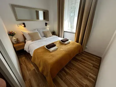 a bedroom with a bed with two towels on it at Old Cracow Apartment I in Kraków