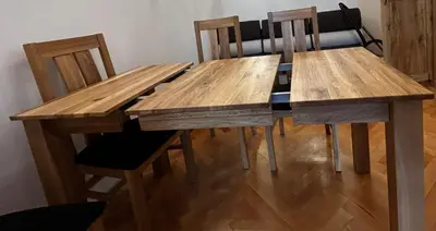 a wooden table with four chairs and a wooden table and chairsuggest at Old Cracow Apartment I in Kraków