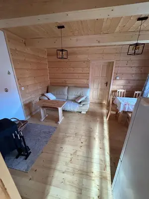 a living room with a couch and a table at Domek Sidzina in Sidzina