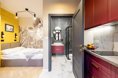 a small bathroom with a bed and a sink at Apartamenty Limanowskiego in Kraków