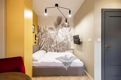 a small bedroom with a bed in a room at Apartamenty Limanowskiego in Kraków