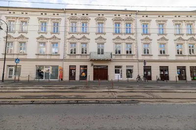 a large white building with a lot of windows at Apartamenty Limanowskiego in Kraków