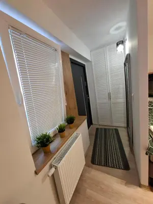 a hallway with a window with plants on it at ApartamentyM&K in Balice